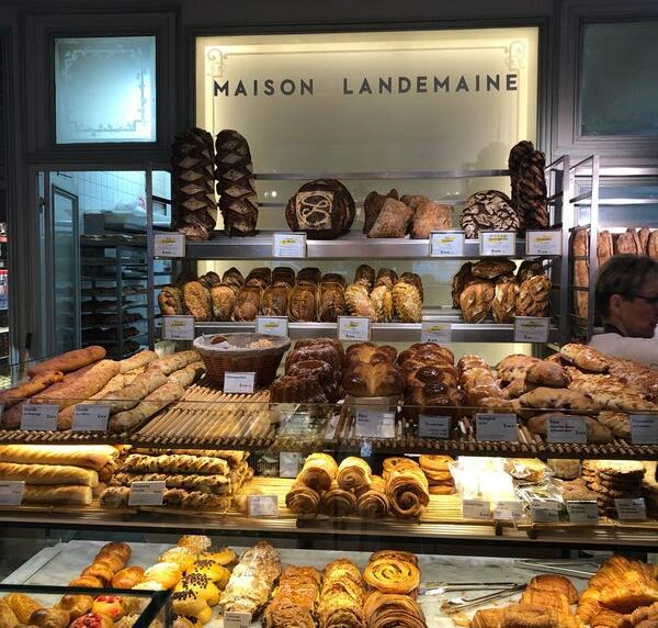 Intérieur de la boulangerie Maison Landemaine avec des pâtisseries exposées sur des présentoirs.